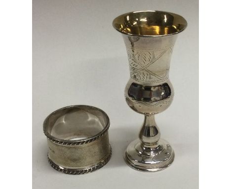 A small silver Kiddush cup together with a napkin ring. Approx. 47 grams. Est. £20 - £30.