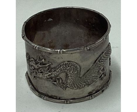 A Chinese export silver napkin ring decorated with a dragon. Approx. 31 grams. Est. £30 - £50.