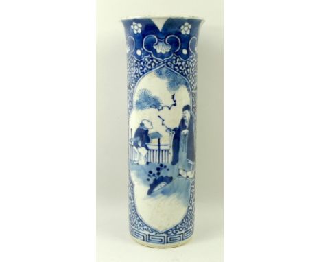 A Chinese porcelain sleeve vase with flared rim, 18th century, decorated in underglaze blue with a scholar and servant in a r