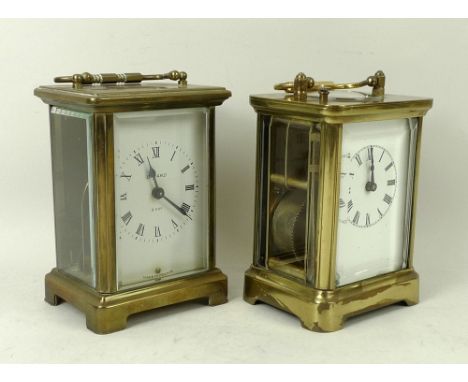 A brass cased carriage clock, white face with Roman numerals, three sides with bevelled glass, and circular glass inset to to
