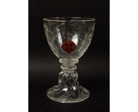 An 18th century French enamelled and engraved wine glass, the bowl engraved with tendrils, with an armorial enamel crest, the