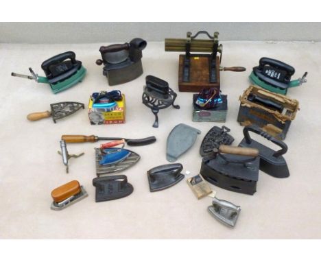 A collection of vintage Victorian and later irons, including a brass crimping iron on stand, a charcoal iron with curved chim