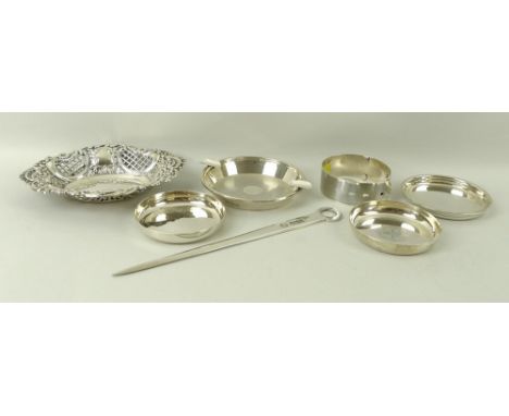 A group of silver items, comprising a bracelet in the form of a belt, an engine turned ash tray, three coasters, a bon-bon di