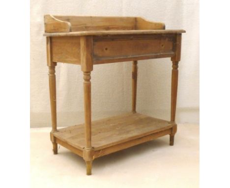 A pine wash stand with single drawer (missing handles) and shelf below, 77 by 44 by 87cm high.