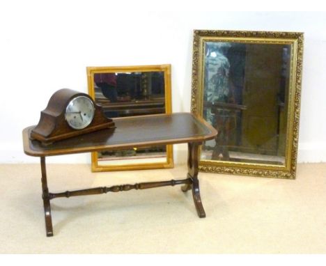 A reproduction leather covered coffee table, 91 by 46 by 43cm high, an oak mantel clock and two mirrors. (4)