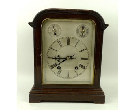 A German mantel clock, eight day movement with silvered face with Roman numerals and two subsidiary dials, chiming, with pend