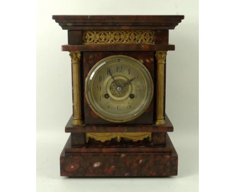 A red and black marble mantle clock, with eight day movement, marked 597, dial with Arabic numerals, 17 by 13 by 23cm. 