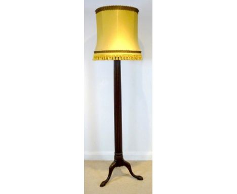 A standard lamp, formed from a 19th century mahogany bedpost with reeded column, raised on three cabriole legs with carved cl