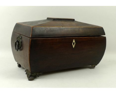 A Regency sarcophagus tea caddy, boxwood strung with mother of pearl inlaid escutcheon, with two brass ring handles, the inte