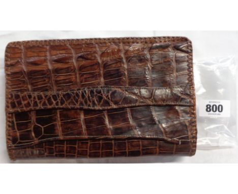 A vintage crocodile skin clutch bag