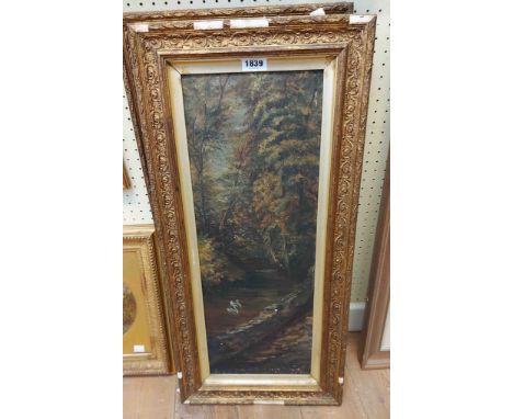 A pair of old gilt framed oils on board in narrow portrait format, one depicting a woodland river, the other a woodland track