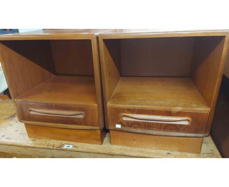 A pair of vintage G-Plan teak effect bedside units with open recess and drawer under, set on plinth bases