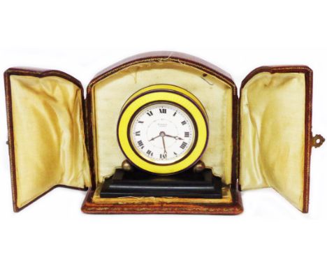 A 7.5cm diameter Art Deco 925 silver cased travelling alarm clock with blue and yellow guilloche enamelled banding and Roman 