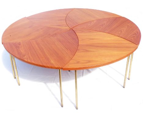 A mid 20th Century Danish teak six section modular pinwheel table comprising six arrow shaped smaller tables, each with brass
