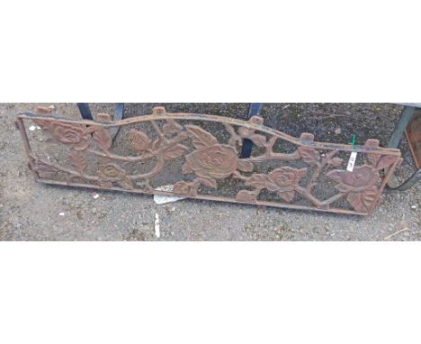 A cast iron bench back with floral decoration