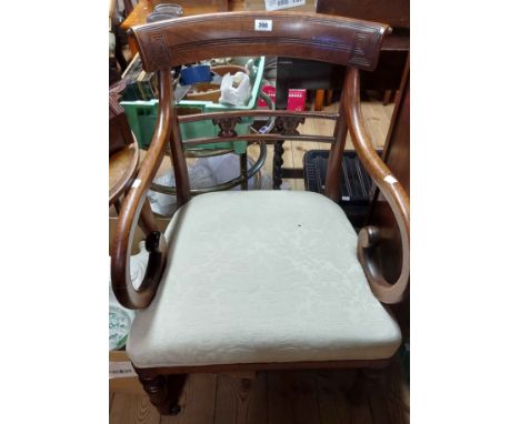 A 19th Century mahogany framed elbow chair with incised curved top rail, open scroll armrests and cream coloured machine tape