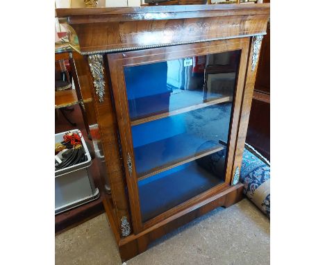 An 82cm 19th Century brass mounted rosewood pier cabinet with material lined shelves enclosed by a glazed panel door, set on 