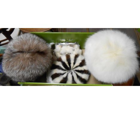 A box containing three vintage fur hats and a similar clutch bag