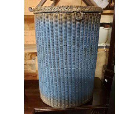 A vintage Lloyd Loom demi-lune laundry basket with original blue sprayed finish and label