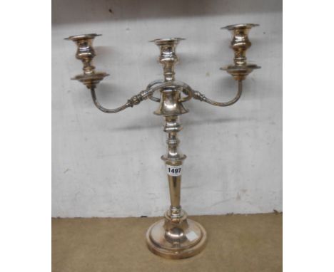A silver plated copper twin branch three light candelabrum with detachable top section