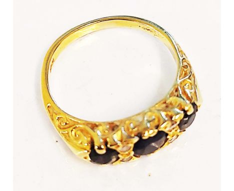 A marked 18k yellow metal ring, set with three sapphires interspersed with two pairs of tiny diamonds - size M