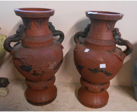 A pair of large Chinese terracotta vases with molded dragon design and handles - impressed seal mark to base