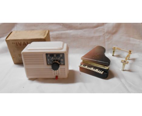 An old wooden box containing a miniature piano trinket box and Ivalek Crystal set receiver