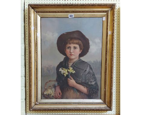 A gilt framed early 20th Century oil on canvas portrait of a child holding a basket of flowers