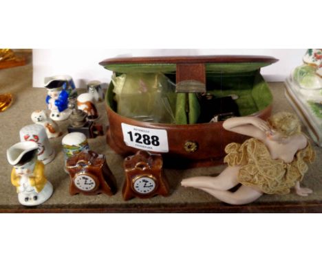 A small jewellery case containing a quantity of miniature items including Sampson &amp; Hancock toby jugs, pair of brass hunt
