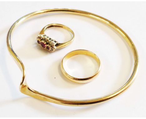 A 375 (9ct.) gold bangle - sold with a 9ct. gold gem set ring and an unmarked yellow metal band - sizes K 1/2 and Q respectiv