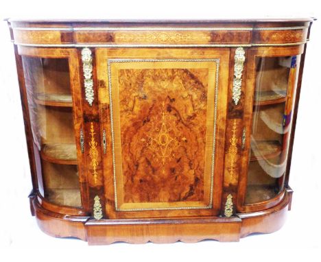 A 1.5m Victorian brass mounted inlaid figured walnut credenza with material lined shelves enclosed by a panelled door, with f