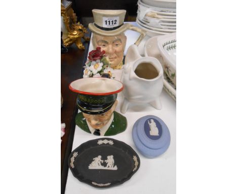 A small collection of ceramic items including Carltonware Harrods commissionaire character jug, white glazed fish form jug, e
