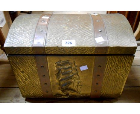 A vintage wooden coal box with brass clad exterior decorated with an embossed clipper design