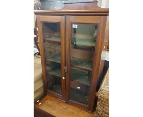 A 66cm late Victorian mahogany cabinet with shelves enclosed by a pair of glazed panel doors - wear