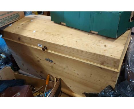 A 1.05cm Victorian style pine lift-top trunk of tapered form with flanking iron drop handles