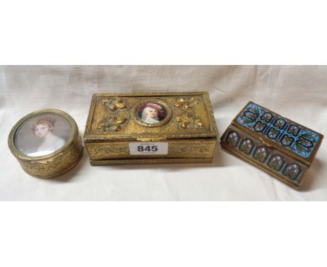 An antique embossed brass lift-top box with fleur-de-lys decoration and inset painted porcelain panel depicting an 18th Centu