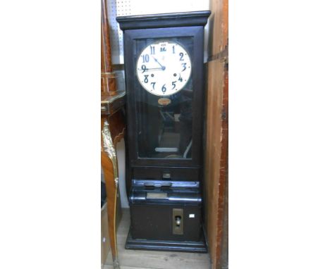 A vintage stained wood cased clocking-in machine enclosed by a glazed panel door marked for 'Time Recorder Supply and Mainten