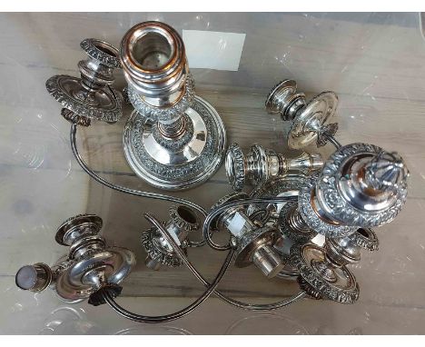 A pair of silver plated twin branch three light candelabra with detachable nozzles