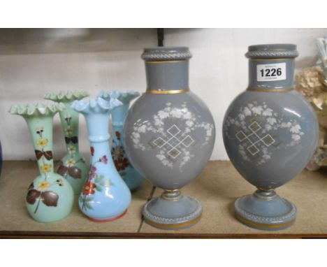 A pair of 19th Century grey opaque glass vases with white enamel and gilt decoration - sold with two pairs of smaller opaque 