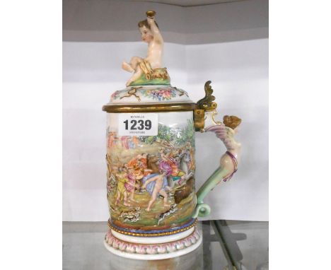 A Nepals porcelain lift-top tankard with typical moulded decoration, depicting boar hunting and scenes of revelry, the handle