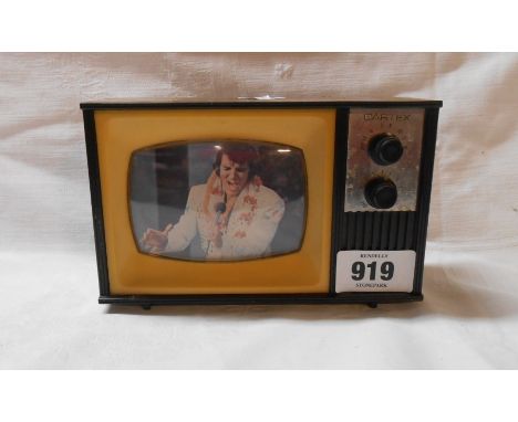 A 1970's Cartex transistor radio of television form with a picture of Elvis Presley to screen