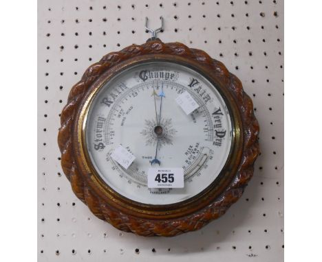 A 20th Century oak cased wall barometer with printed dial and rope twist border