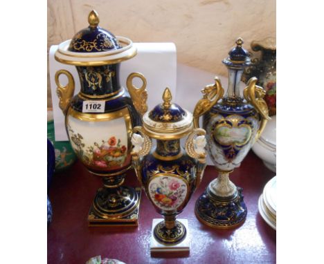 A large 19th Century bone china vase of baluster form with dolphin handle and central hand painted panel on a cobalt blue gro