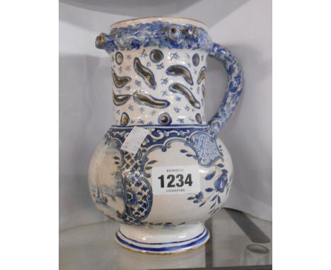 An antique delftware puzzle jug of tankard form with central panel, depicting a sailing boat on a lake