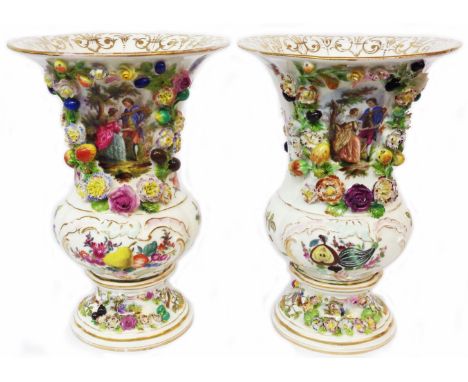 A pair of German porcelain vases of urn form each decorated with encrusted flower a fruit decoration around and central hand 