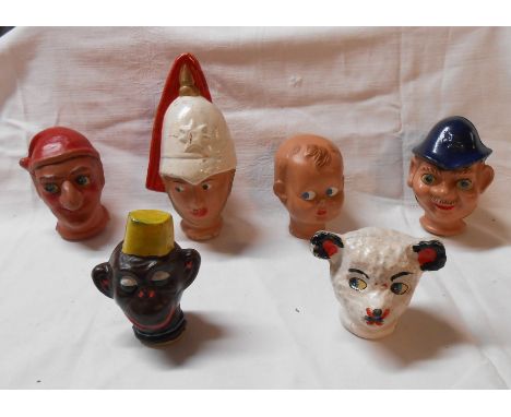 A box containing six vintage puppet heads