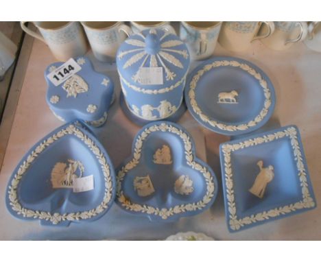 Seven pieces of Wedgwood blue Jasperware comprising trinket box, lidded jar, and pin dishes