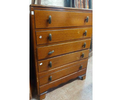 A 77cm vintage oak chest with flight of five long drawers, set on moulded bracket feet