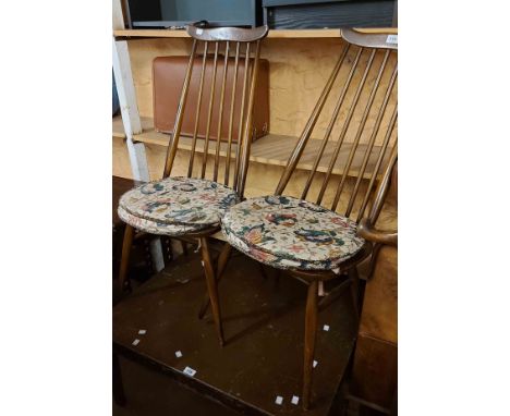 A pair of Ercol dark elm high stick back dining chairs with moulded solid seats