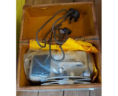 A vintage Eumig projector in wooden carry case - sold with a quantity of films